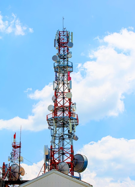 Cell tower with antenna against blue sky