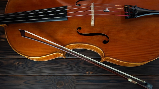 cello lies on a wooden surface