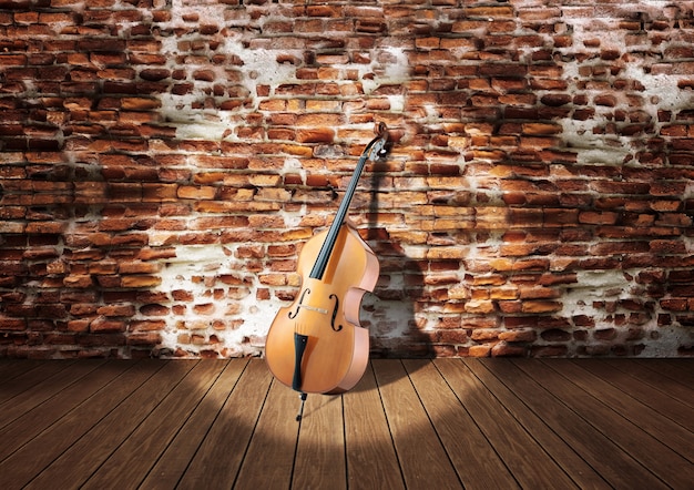 Foto violoncello sul palco appoggiato al muro di mattoni rustici