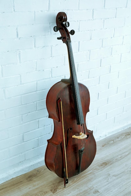 Photo cello on white brick wall background