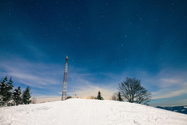 Cellular tower against background starry night sky