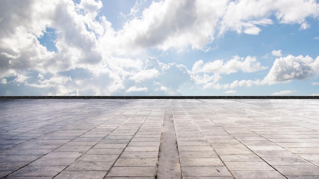 cement floor view with blue sky and clouds in the background