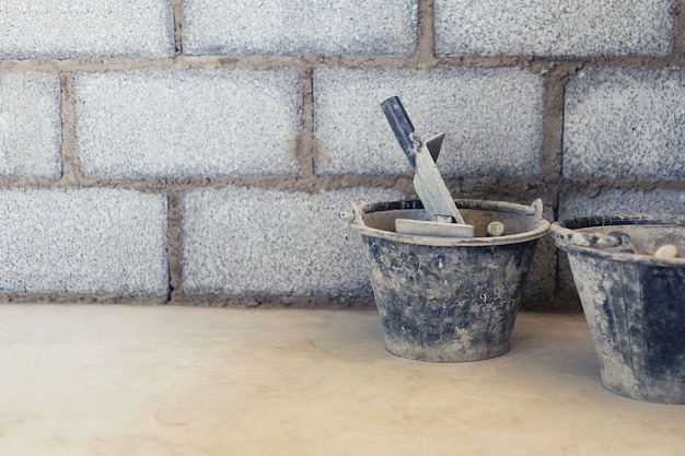 Cement tank and scoop into brick blocks in construction area