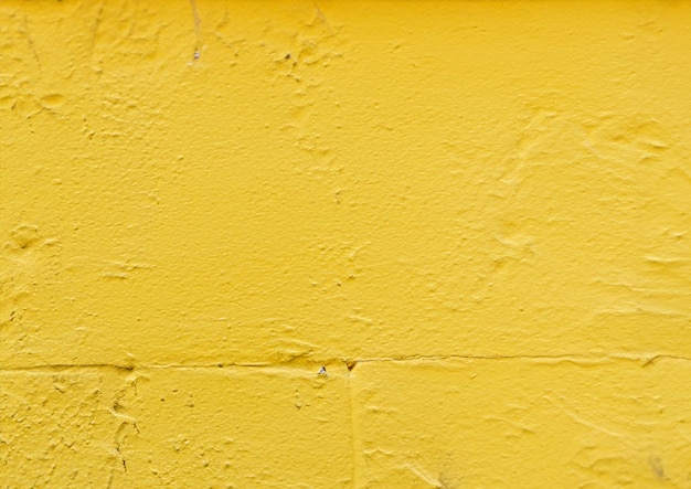 Cement wall painted with yellow paint