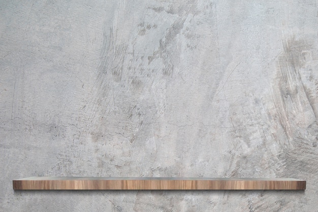 Cement wall with empty wooden shelves.