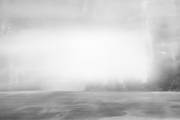 Photo cement wall with floor in the empty room with light transmitted through the window for background