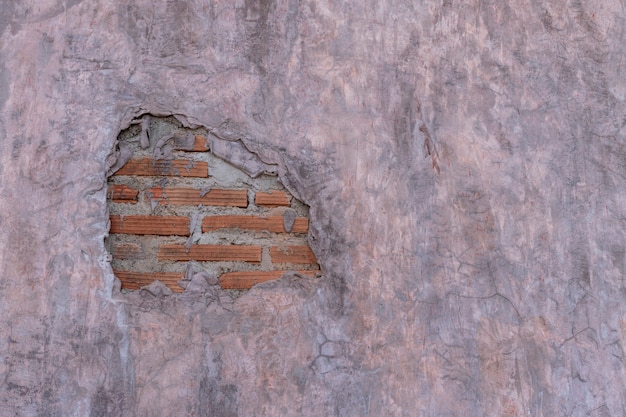 Foto cementmuur in loftstijl met barst en oranje baksteen