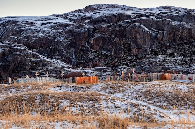 Cemetery on the background of hills on the Arctic coast in Teriberka