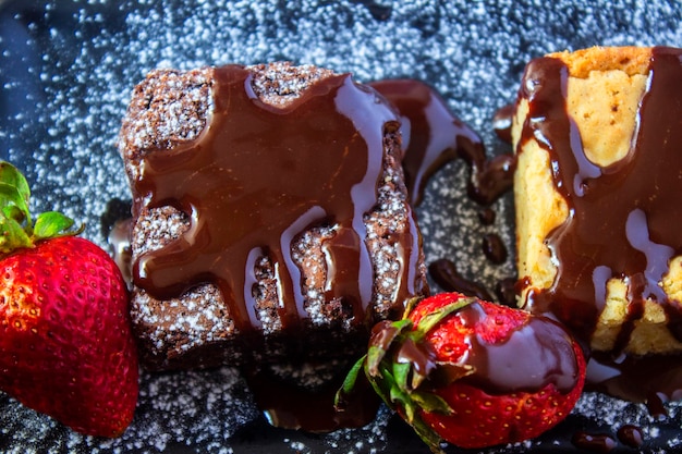 Cenital of brown and white chocolate brownie cake with strawberries