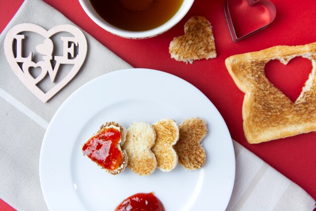 Cenital view of romantic breackfast with toast and jam