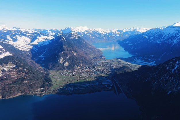 The center of Bernese Apline city of Interlaken in winter Swiss Alps, helicopter view. Thun Lake and Brienz Lake on background