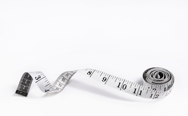 centimeter measuring tape with inches rolled up on a white background isolate