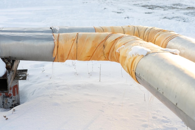 Photo central heating pipes wrapped with a repair patch made of yellow insulating material