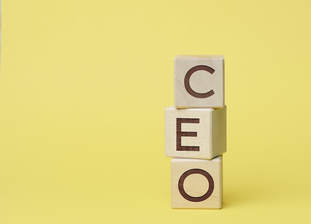 CEO inscription on wooden cubes, yellow surface