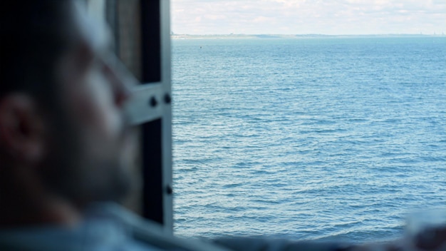 Ceo man holding glass at sea window closeup boss relaxing at\
official journey