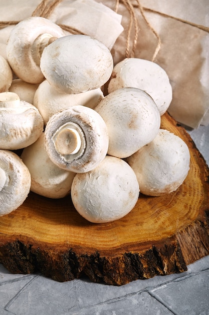 Ceps of champignon nature, wooden and gray background. mushrooms close-up. Fresh ripe pure porcini champignon.