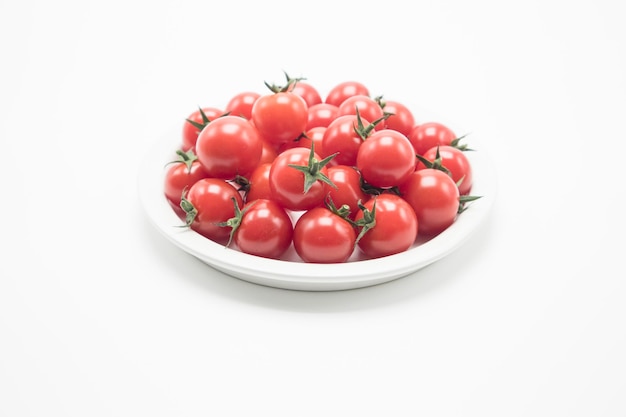 The ceramic bowl is full of tomatoes cherry