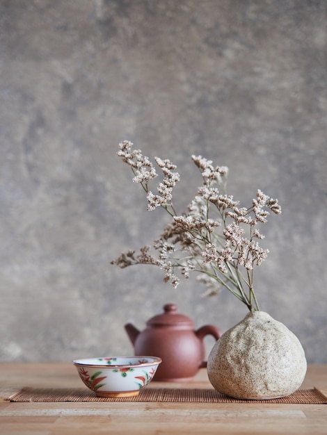 Ceramic bowl and vase against teapot