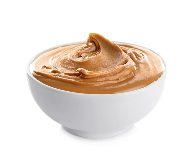 Premium Photo Ceramic bowl with creamy peanut butter isolated on white