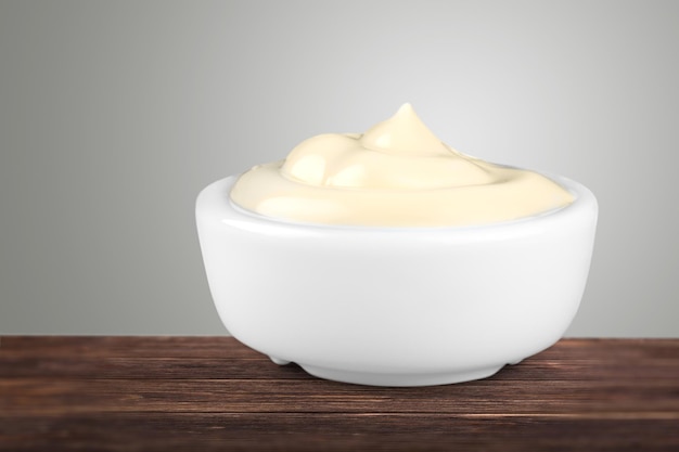 Ceramic bowl with sauce or cream on the desk