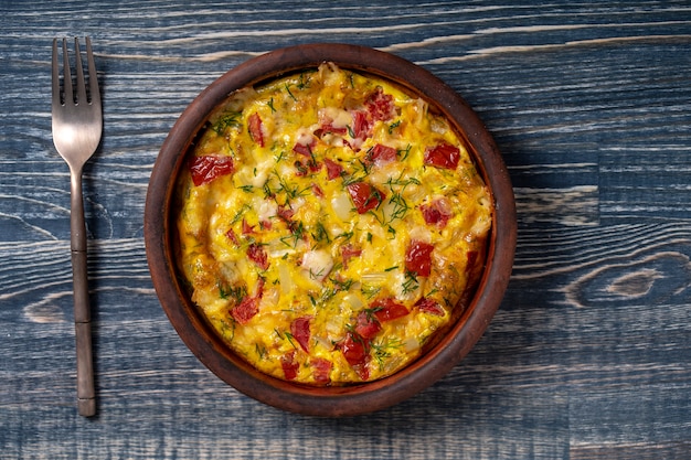 Ceramic bowl with vegetable frittata, simple vegetarian food.