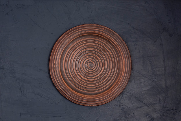 Ceramic brown plate on a black desk