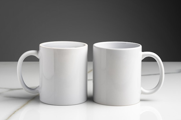 Ceramic cups on marble table against gray background