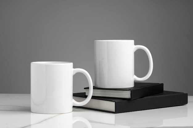 Ceramic cups on marble table against gray background