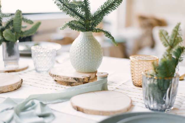 Ceramic and glass vases with Christmas tree branches