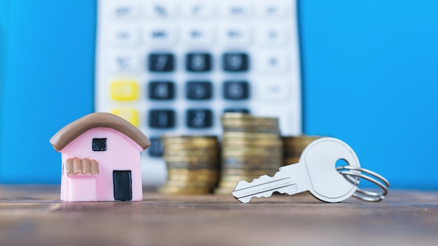 Ceramic model of a house with the coins and key