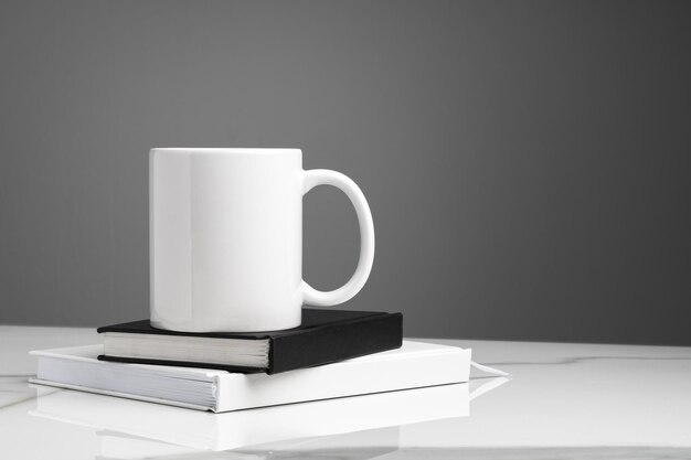 Ceramic mug on marble table on gray background