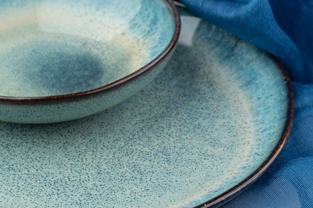 Ceramic plate on a wooden table top view. minimalist handmade ceramic tableware and pottery