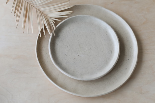 Ceramic plate on a wooden table top view minimalist handmade ceramic tableware and pottery