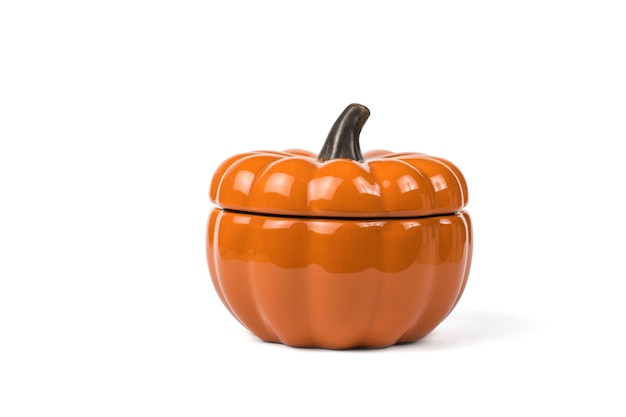 Ceramic pumpkin with lid insulated on a white background. Colorful tableware for the holiday.