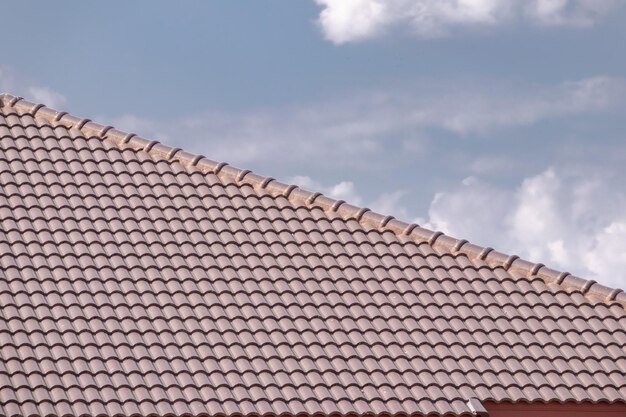 Ceramic roof tiles on the house with blue sky