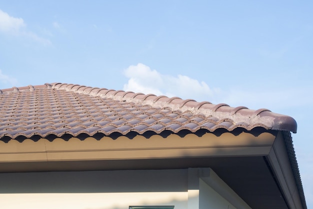 Ceramic roof tiles on the house with blue sky