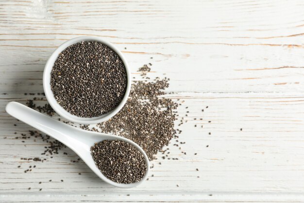 Ceramic sauce boat and spoon with chia on wooden