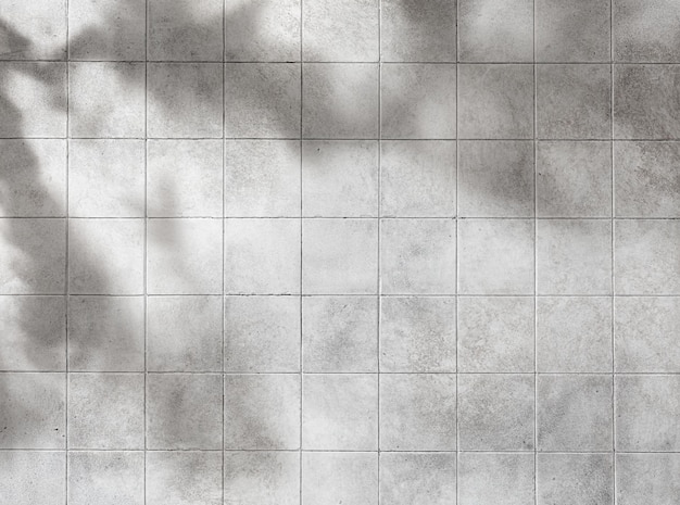 Ceramic surface for wall background with tile texture and leaves shadow