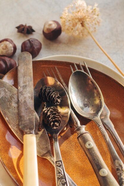 Ceramic tableware and cutlery on stone table selective focus