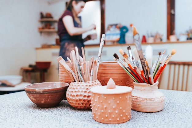 Ceramics master prepares to paint pottery.