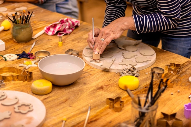 Photo ceramics workshop elderly woman working with ceramics