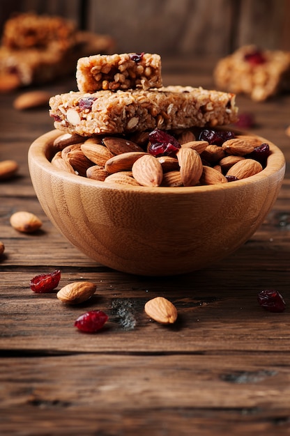 Cereal bar with almond and berry on thw wooden table