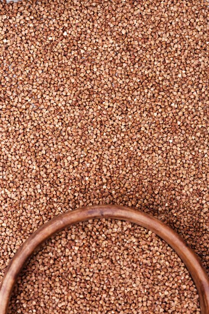 Photo cereal buckwheat close up as background. buckwheat croup. healthy food. natural organic grain. vertical format image