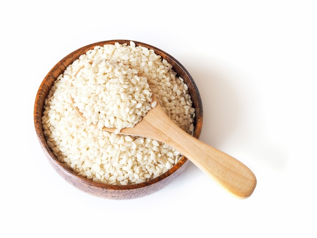 Cereal dried food whole grains with white sesame seeds in wooden bowl and spoon 