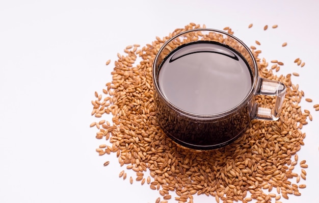 A cereal drink to replace coffee. Cup with coffee on a white background. Copy space