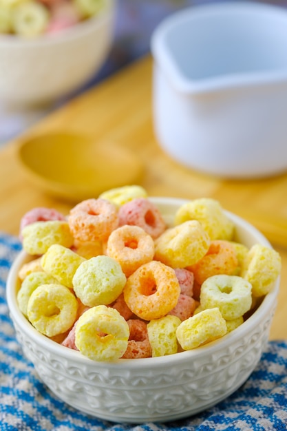 Cereal flakes in white bowl with copy space,Breakfast concept.Food with delicious fruity taste and fruity colours