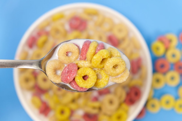 Cereal rings with milk closeup in spoon