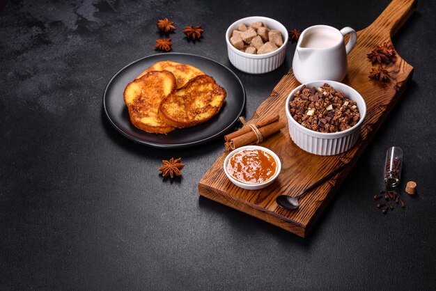 Cereal with chocolate milk and bread in an egg against a dark concrete background