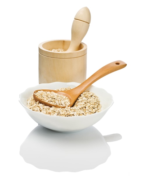 Cereals in dish with spoon and mortar