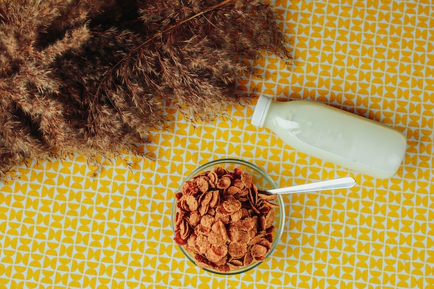 Cereals, spoon and milk bottle on the table. Healthy nutrition, healthy food on the table.